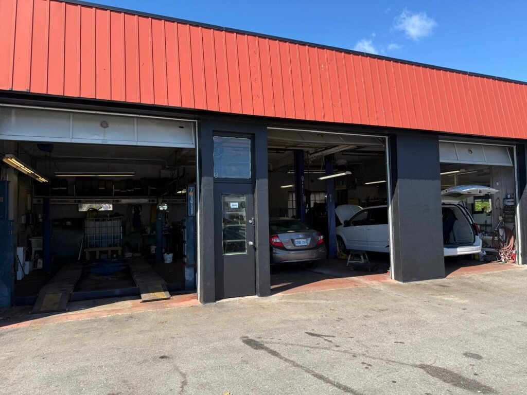 S.P.D. Auto Repair open service bays with vehicles being serviced S.P.D. Auto Repair open garage bays with vehicles being serviced